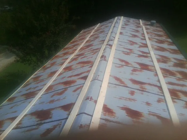 Rusted metal roof panels with new wood purlins before replacement — Storm Damage Roof Repair in Belfair by Roofing Brothers